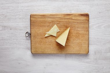 Mozzarella pizza cheese isolated on wooden board top view whiteb