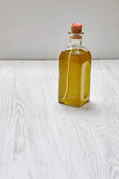 Bottle of artisian olive oil virgin extra isolated on wooden tab — 스톡 사진