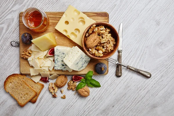 Four cheeses with supplements, dried bread, figs and other  top — 스톡 사진