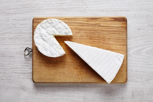 Cheese art camembert brie wooden desk white table top view — Stockfoto