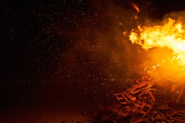 Sparks from big huge fire flying in night