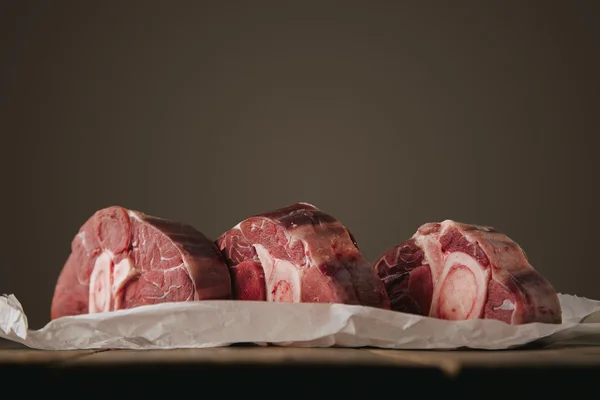 Three fresh raw meat steaks with bone side — Stock Photo, Image