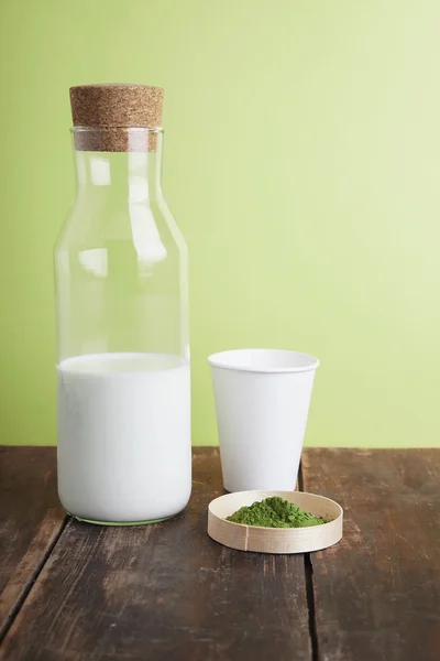 Botella de leche llena, matcha, vaso de papel en la espalda verde — Foto de Stock