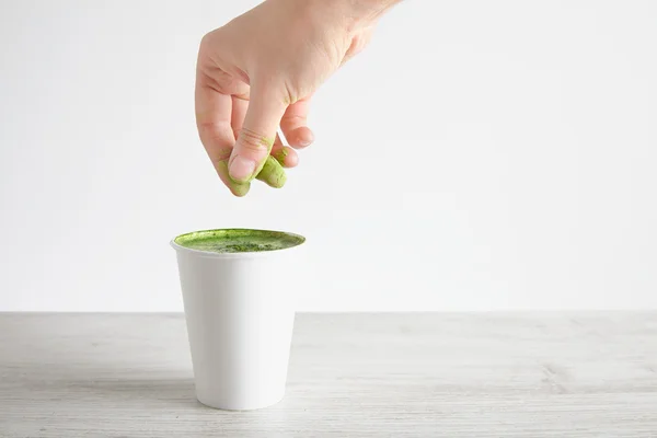 Woman pours green powder in matcha latte — Stok fotoğraf