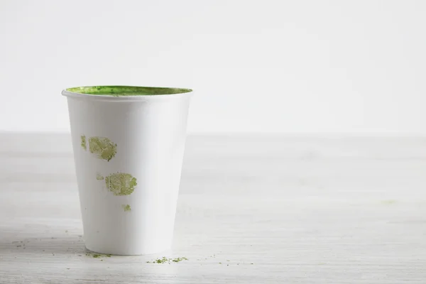 Matcha tea latte in paper glass with fingerprints — Stok fotoğraf