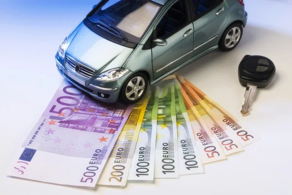 Car with key and bills — Stock Photo, Image