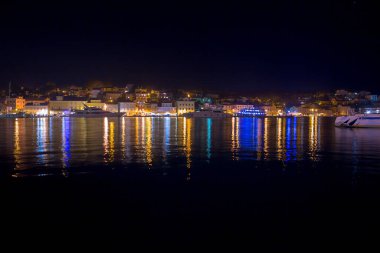 Mali Losinj limanı ve limanının eski Mali Losinj kasabasındaki gece manzarası. Limandaki lüks yatlar, tekneler ve diğer gemiler. Adriyatik Denizi 'ndeki Hırvat adalarında yaz tatili.