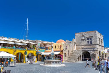 Rhodes, Greece - June 29, 2021: sightseeing place at hot summer sunshine afternoon. Tourists at the intersection Aristotle Str\Socrates Str- Hippocrates square at the Rhodes old town of Rhodes, Greece