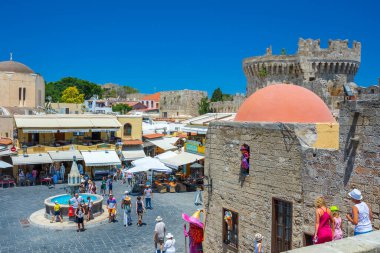 Rhodes, Greece - June 29, 2021: sightseeing place at hot summer sunshine afternoon. Tourists at the intersection Aristotle Str\Socrates Str- Hippocrates square at the Rhodes old town of Rhodes, Greece