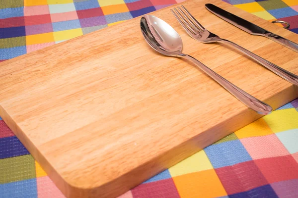 Fork, Knife and Table Cloth on wooden background. Top View