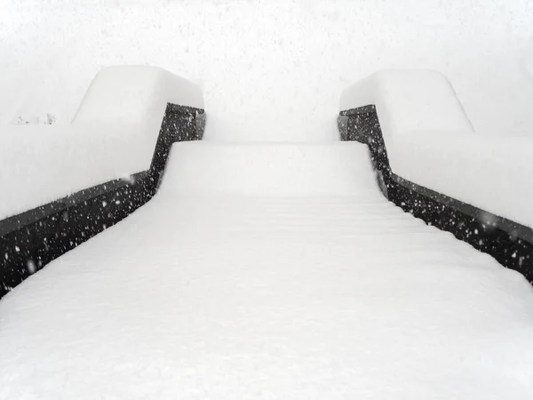 Trappan är beströdd med ett jämnt lager snö på en dimmig dag under kraftigt snöfall — Stockfoto