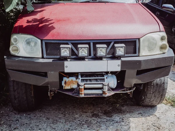 Front of a red car with many headlights and a bare starter winch — Stock Photo, Image