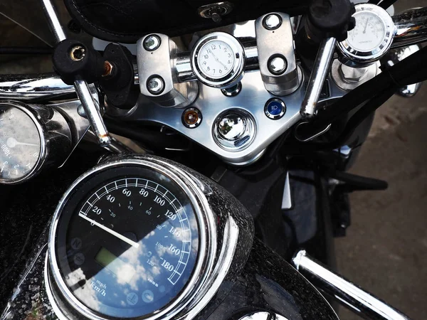 Dashboard of a black motorcycle located on the handlebars and body. Closeup photo — Stockfoto