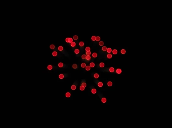 Macchioline di bokeh rosso brillante su uno sfondo scuro. Sfondo astratto — Foto Stock