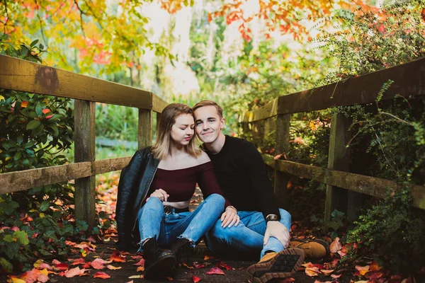 恋爱中的年轻的高加索夫妇在大自然中享受着幸福的时刻。在秋天的公园里,这个年轻人在浪漫的约会中拥抱了他的女朋友.秋天的心情有选择的重点。复制空间. — 图库照片