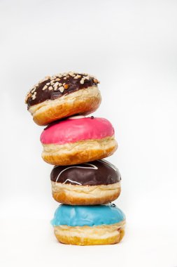 Tower of Assorted colourful  Donuts on a white background
