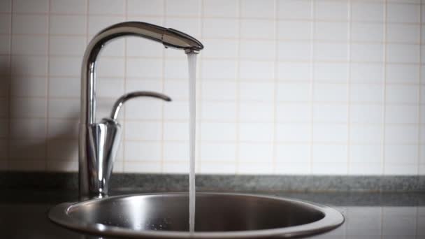 Hälla vatten i ett glas i köket — Stockvideo