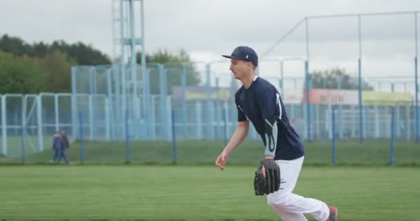 Honkbal toernooi, de werper vangt een fastball en stuurt een pass, sport op de universiteit. — Stockvideo