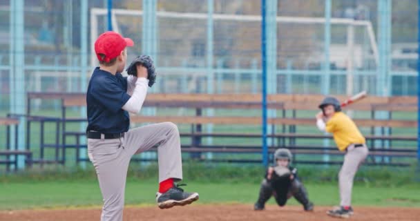 Torneo di baseball a scuola, i ragazzi giocano a baseball, il lanciatore lancia la palla verso un battitore, battitore colpisce con successo una palla veloce, 4k rallentatore. — Video Stock