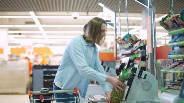 Mann kauft Gemüse und Obst in einem modernen Supermarkt, kontaktlosen Kauf von Produkten in einem Geschäft, den Kaufvorgang über eine Selbstbedienungskasse und NFC. — Stockvideo