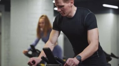 Erkek ve kadın bisiklet eğitimi, spor salonundaki simülatörlerde aerobik dayanıklılık eğitimi, bisiklet eğitimi....