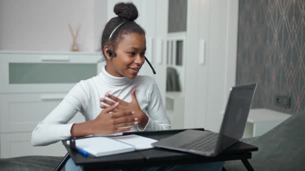 Distance learning and homeschooling online, african teen girl uses a laptop and screen tablet to studying during a pandemic, quarantine, remote learning at school. — Stock Video