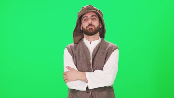 Ritratto di un uomo dall'aspetto arabo in abiti tradizionali, un uomo sullo sfondo di un cromakey, veduta di un volto di persone, rallentatore. — Video Stock