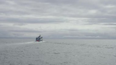Infinity ocean landscape, view of the ship sailing of the open water, view of the huge water texture, Iceland outdoors nature background.
