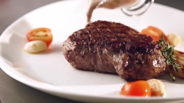 Grill smocked barbecue steak with a flowing sauce in slow motion — Stock Video