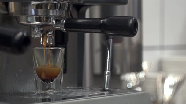 Espresso machine makes espresso and it pours into a small cup in slow motion — Stock Video