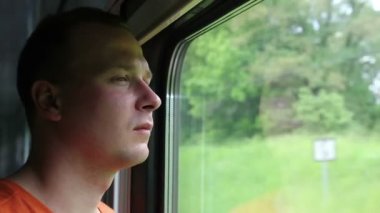 Pencereden bakarak tren ile seyahat eden adam
