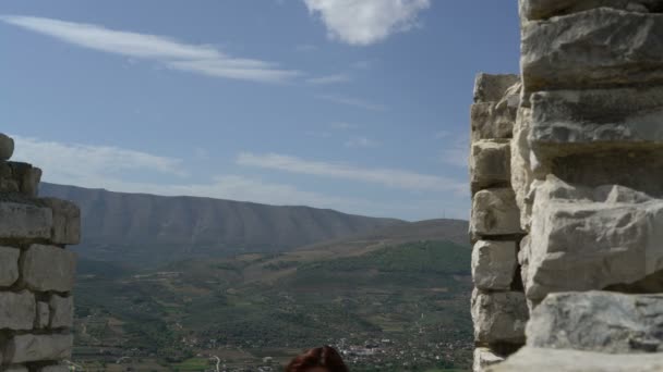 Woman tourist walking by stairs of ancient castle, old ruins, history, travel concept, blue sky — Stock Video