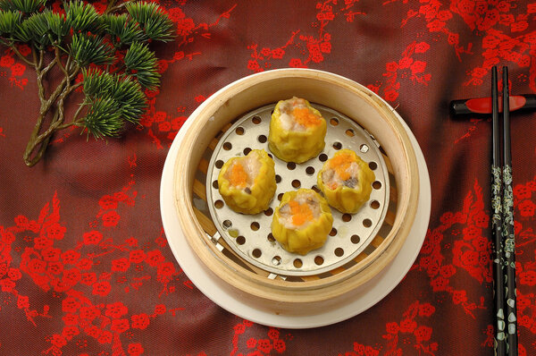 yumcha.   dim sum in bamboo steamer with chinese bun , pao , bao zi , steamed dumpling , shumai on table in chinese restaurant. chinese cuisine.Crab roe shao-mai