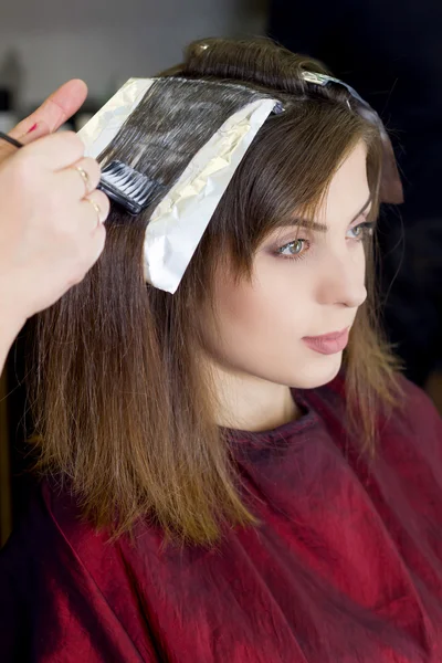 Женщина в парикмахерской красит своего наследника — стоковое фото