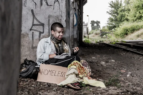 Homeless woman smoking — Stock Photo, Image