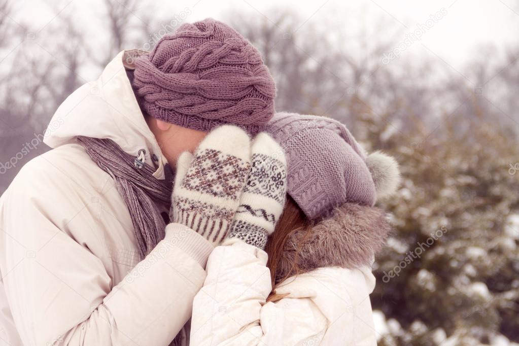 Kissing couple in park in winter