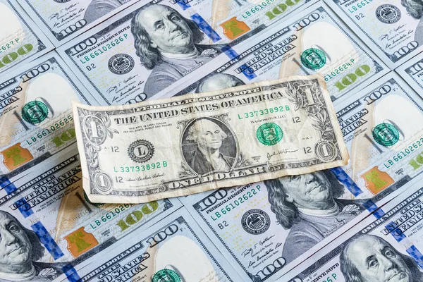 Old one dollar on one hundred dollars background — Stock Photo, Image