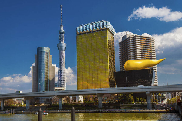 Tokyo, JAPAN, MARCH 13, 2019 - View of Sumida District with the iconic Asahi Beer Hall buildings and Skytree Tower