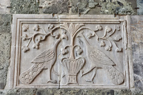 Ancient relief of two peacocks