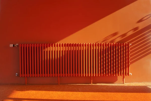 Orange radiator in a retro orange room Royalty Free Stock Photos