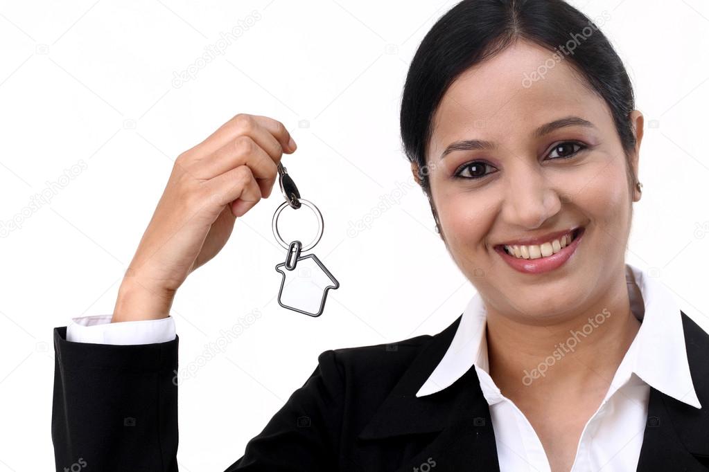 Cheerful businesswoman holding house key