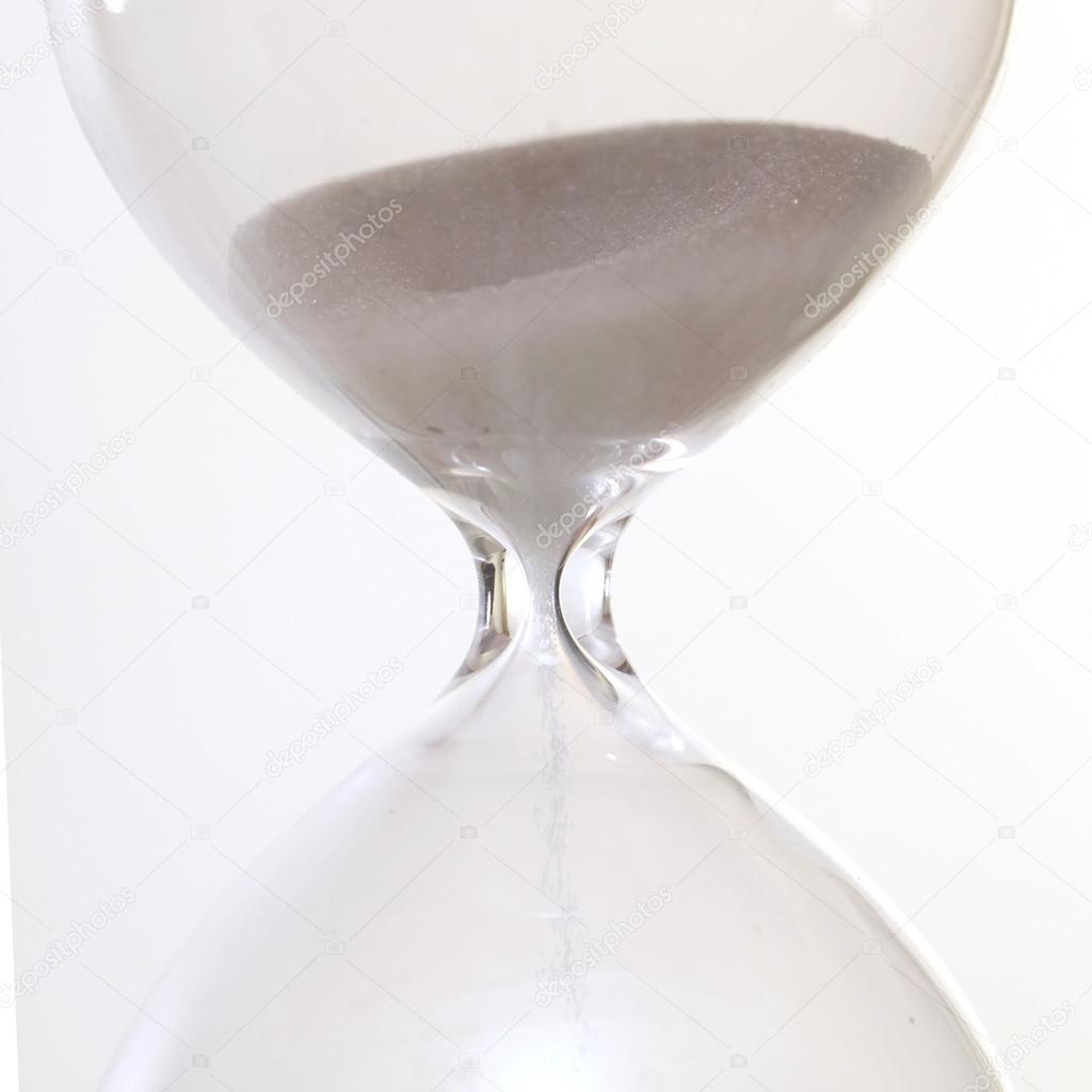 Sand passing through the glass bulbs of an hourglass