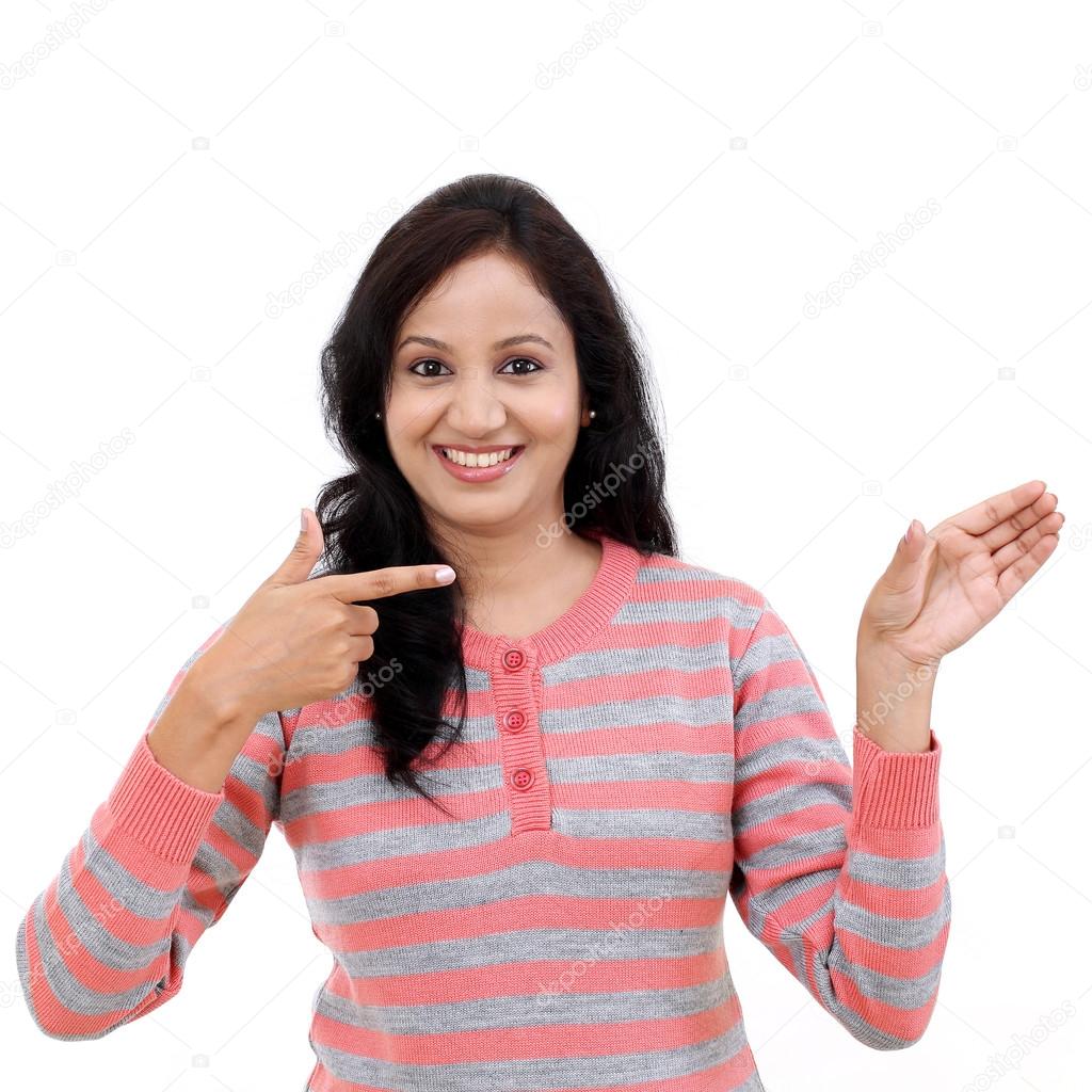 Young woman showing the palm to a blank copy space