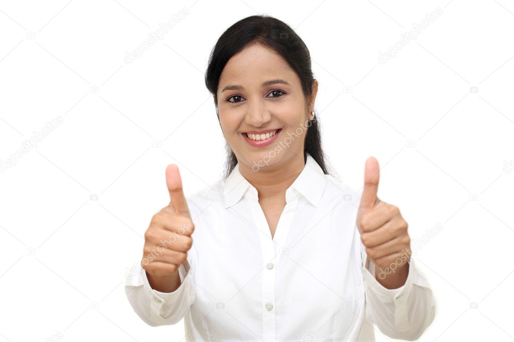 Cheerful woman with thumbs up against white background