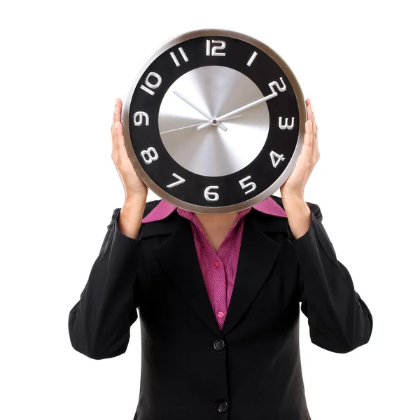 Empresária segurando relógio sobre o rosto isolado no branco — Fotografia de Stock