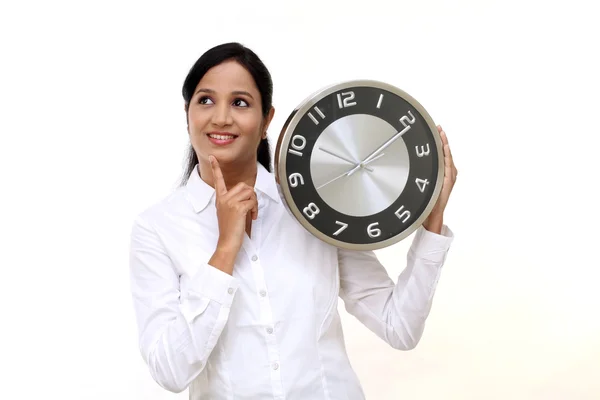 Young business woman holding clock in hands — Stock Photo, Image