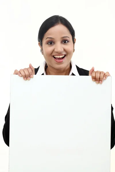 Happy business woman showing blank signboard — Stock Photo, Image