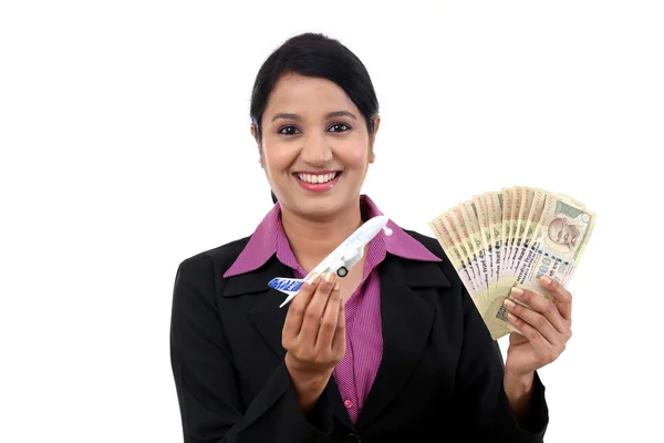 Joven mujer de negocios con dinero y juguete avión —  Fotos de Stock