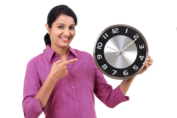 Young business woman holding clock in hands — Stock Photo, Image