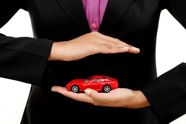 Business woman with a toy car in her hand — Stock Photo, Image